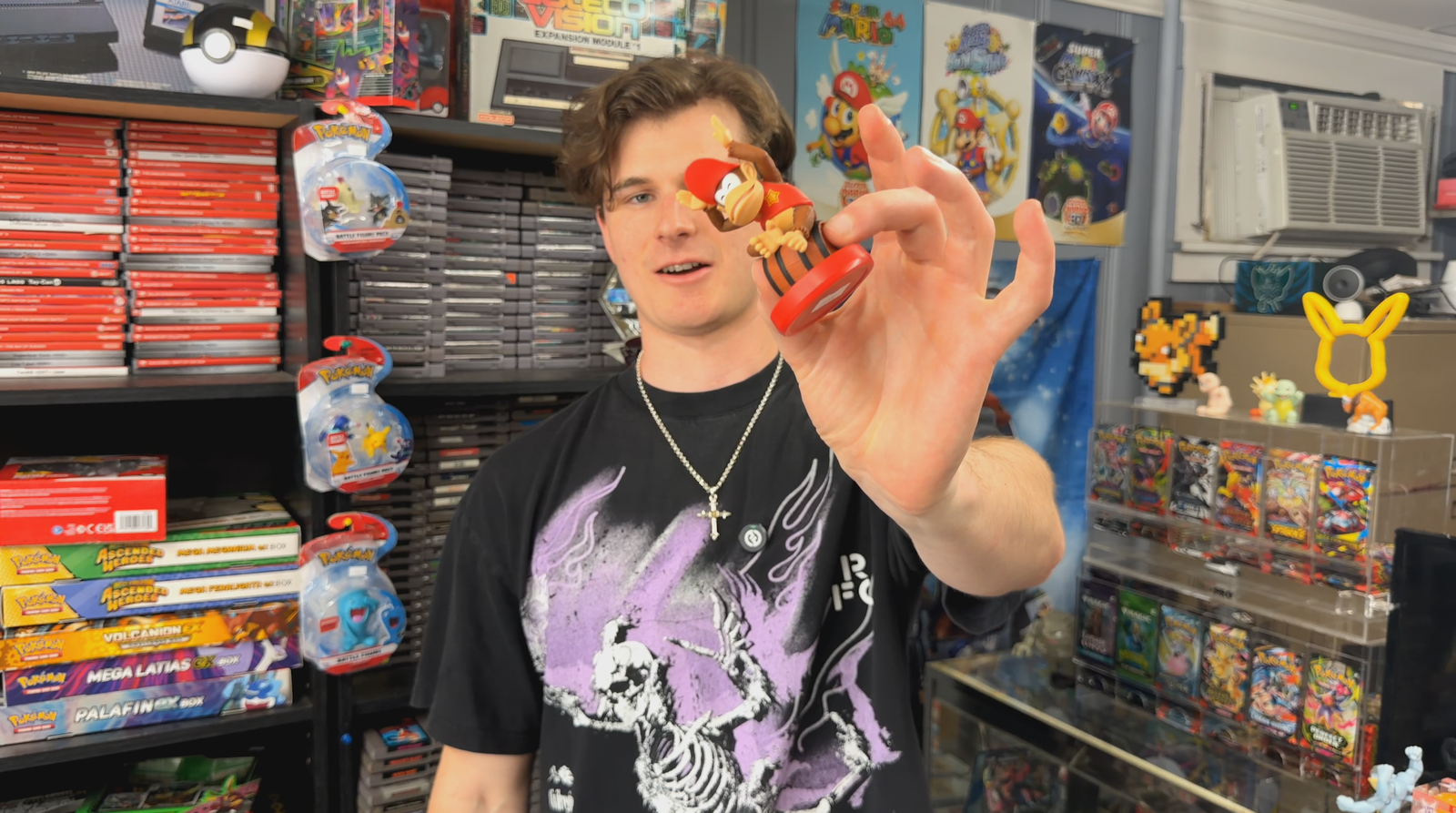 Power Down holding up diddy kong amiibo in a retro game store